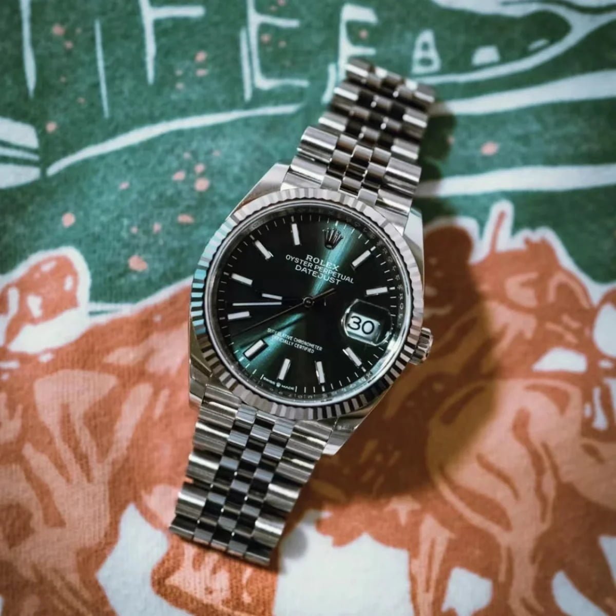 Green Datejust-style watch illustrating recognizable design appeal