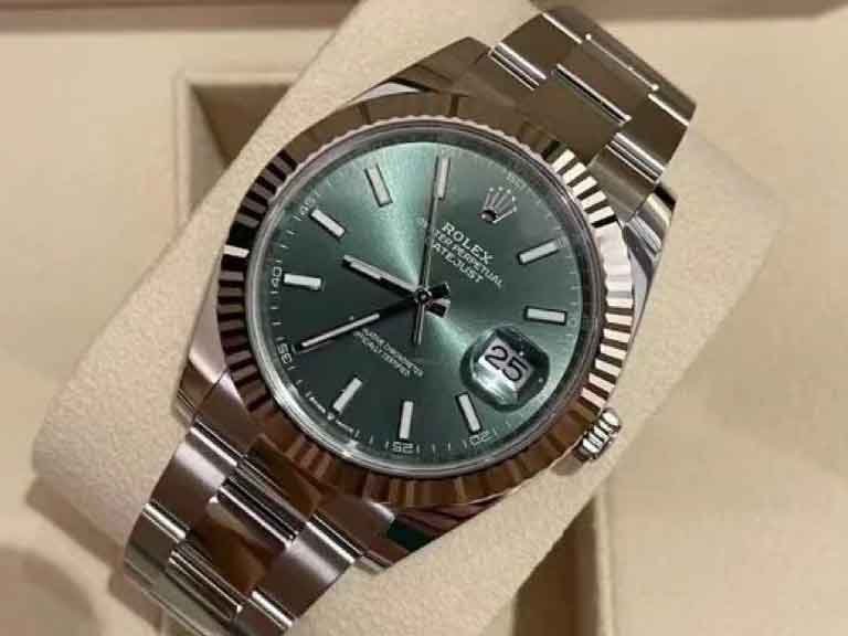 Green Datejust-style close-up for accuracy comparison