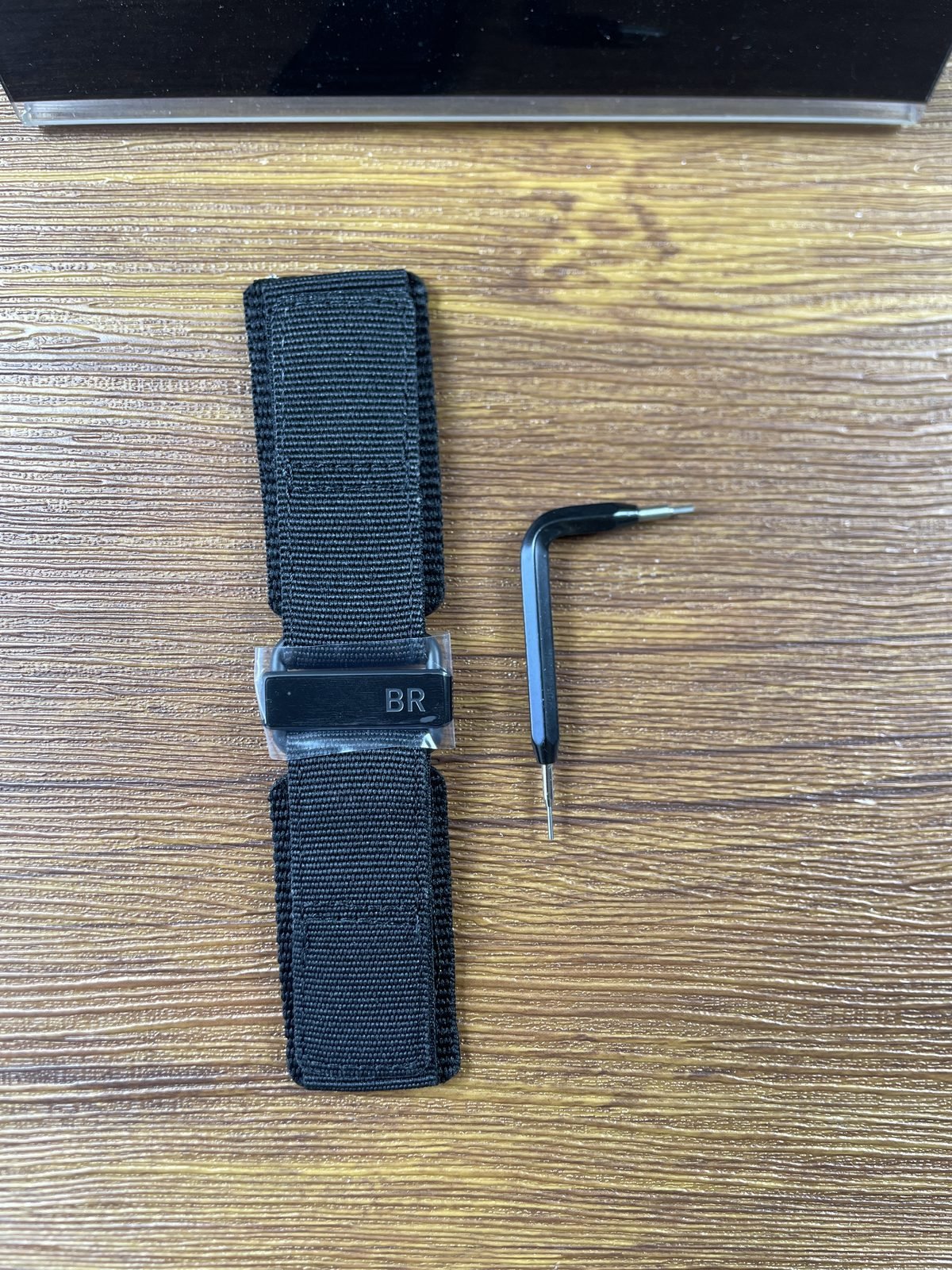 Bell and Ross BR-03 Astro replica black woven spare strap BR marked buckle and change tool front