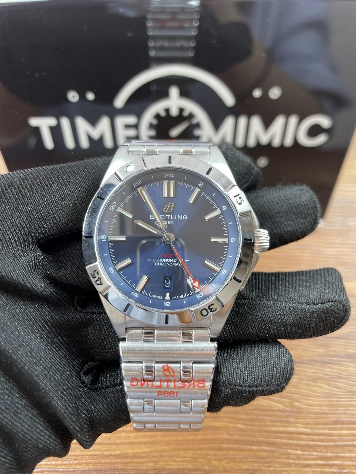 Breitling Chronomat A32398101C1A1 replica blue sunray-style dial red GMT arrow date at six rider-tab bezel and Rouleaux-style bracelet front