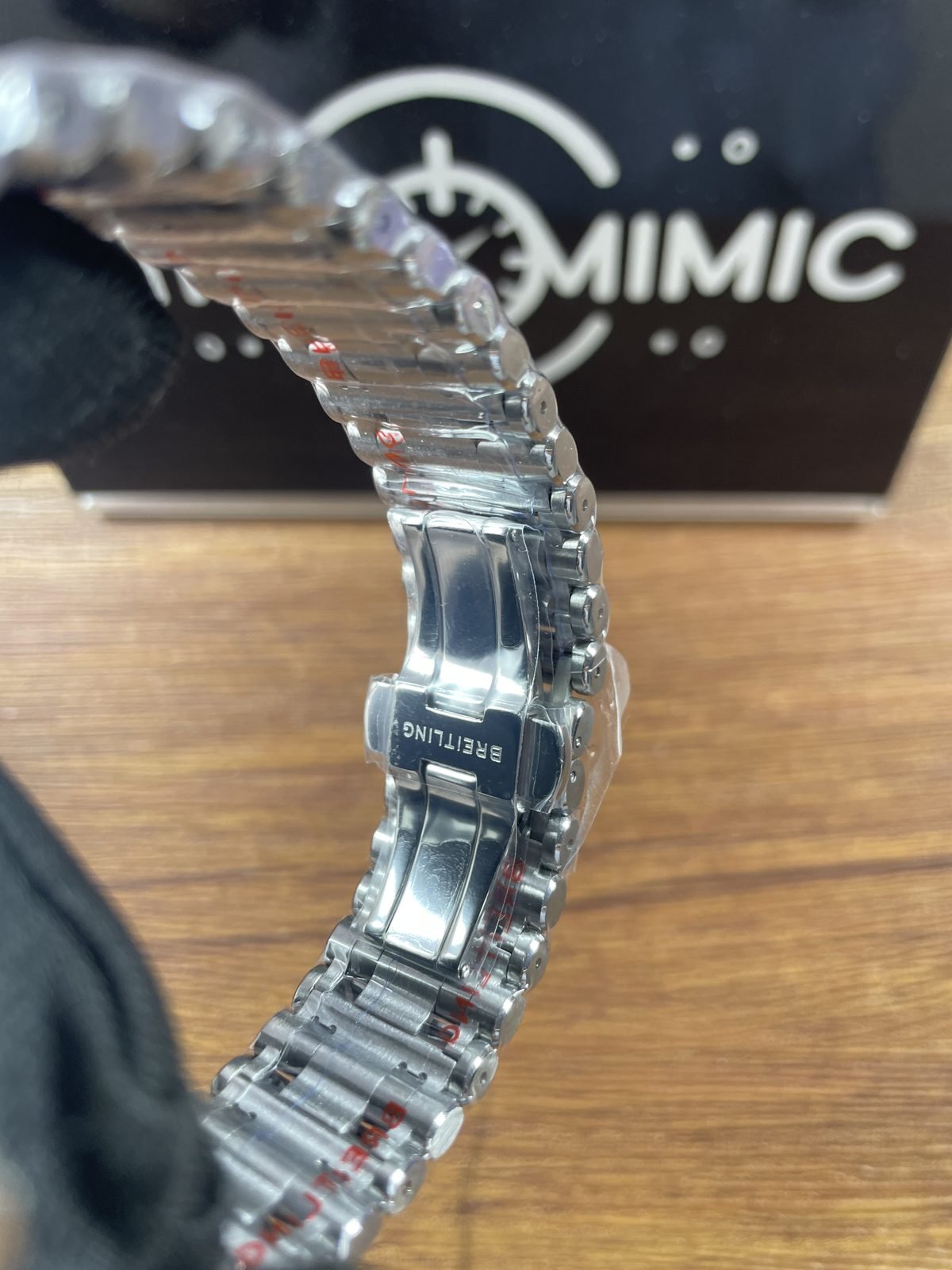 Breitling Chronomat AB0134101C1A1 replica outer clasp engraving and rounded bracelet links under protective film