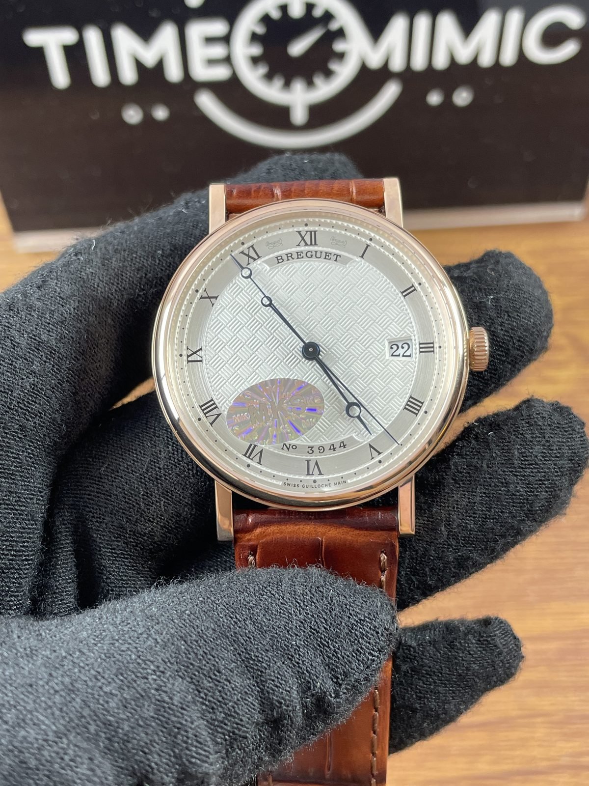 Breguet Classique 5177BA replica warm gold-tone case silver textured dial Roman numerals blue-looking hands and brown strap front