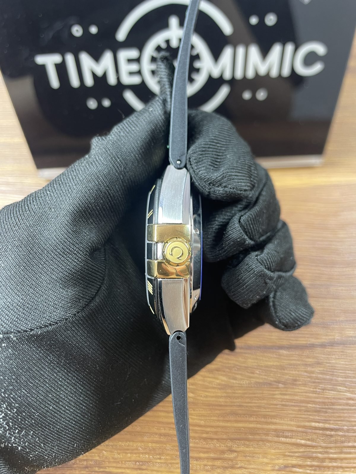 Omega Constellation green dial replica crown side with gold tone crown claws and steel tone case
