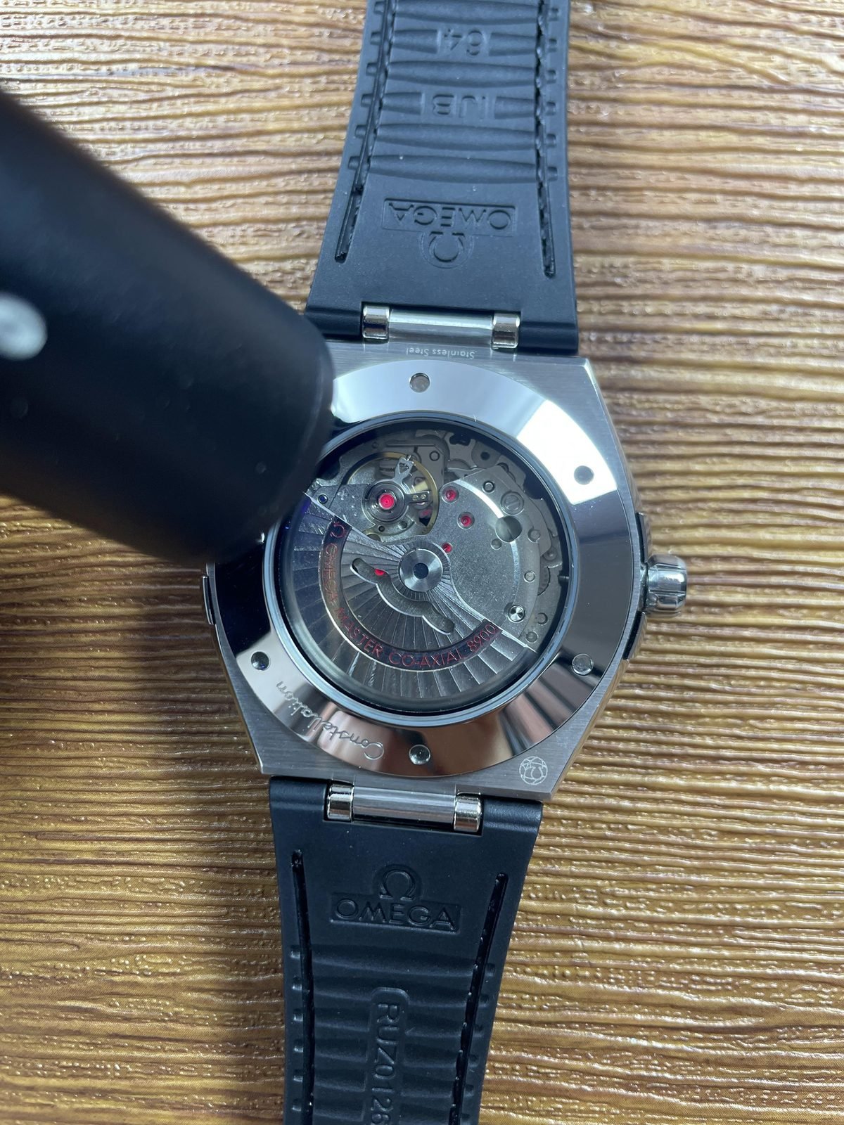 Omega Constellation replica displayed movement under inspection light with red jewel like elements