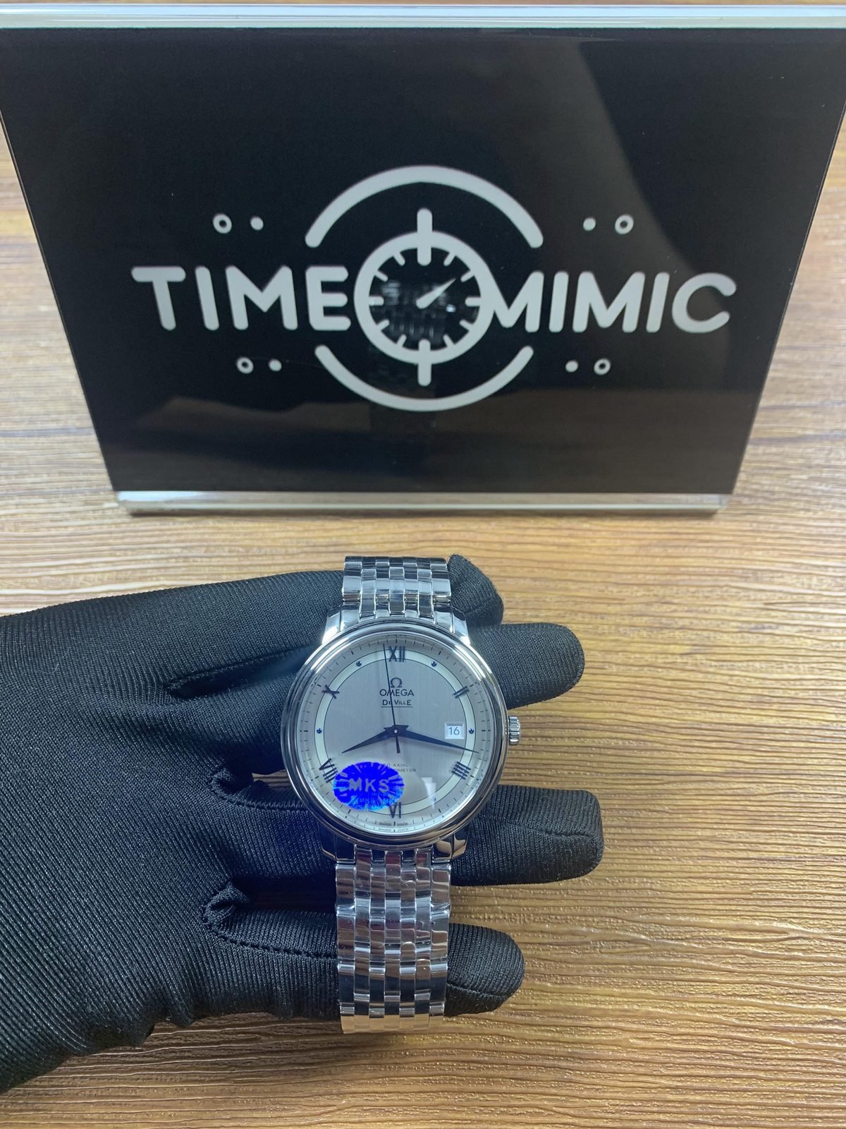 Omega De Ville 424.10.40.20.02.001 replica silver vertically textured dial blue hands Roman numerals date and steel bracelet front