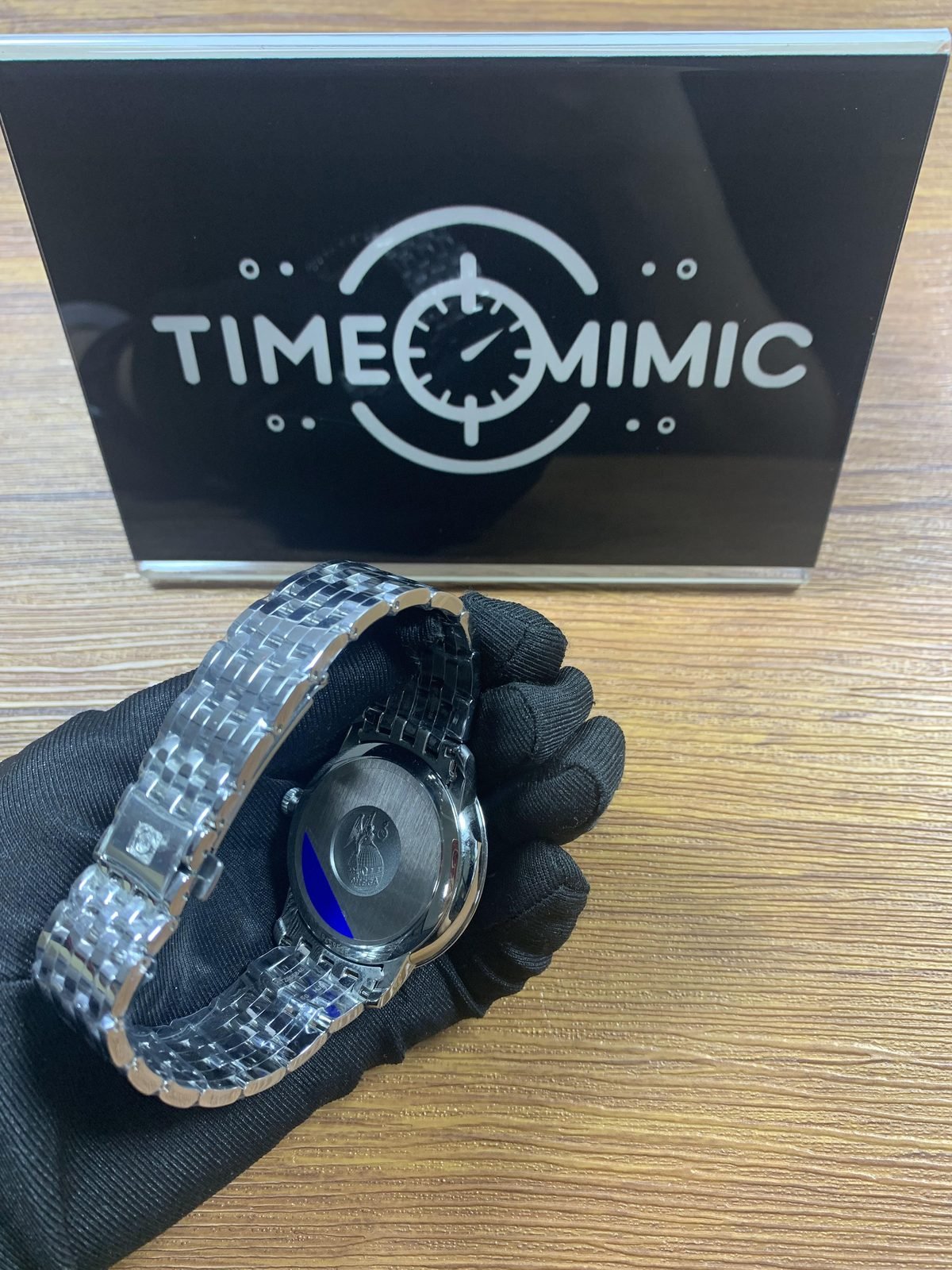 Omega De Ville replica solid brushed caseback with observatory style medallion and blue protective film