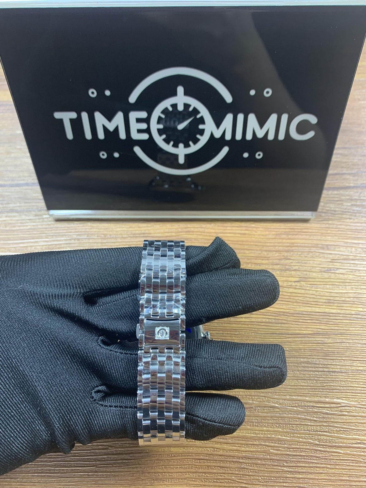 Omega De Ville replica steel-tone bracelet clasp exterior with logo under protective film