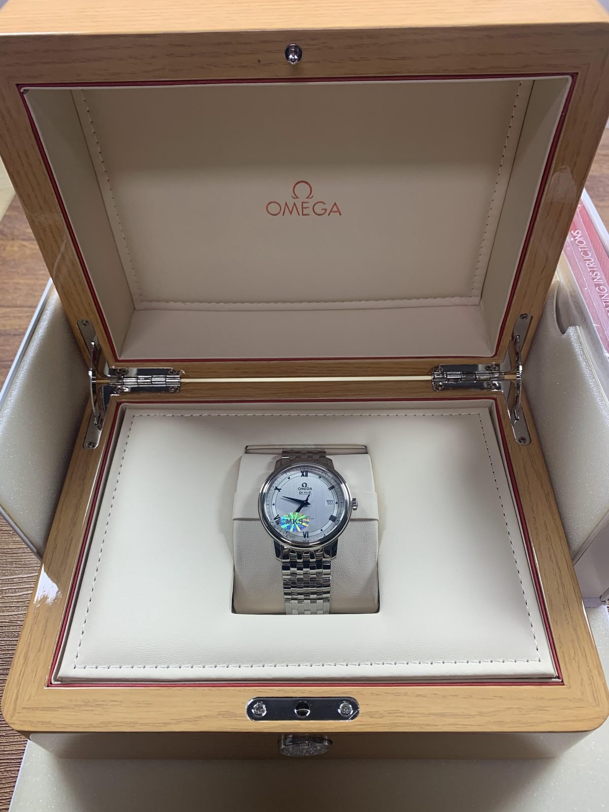 Omega De Ville replica presented inside a wooden Omega style watch box