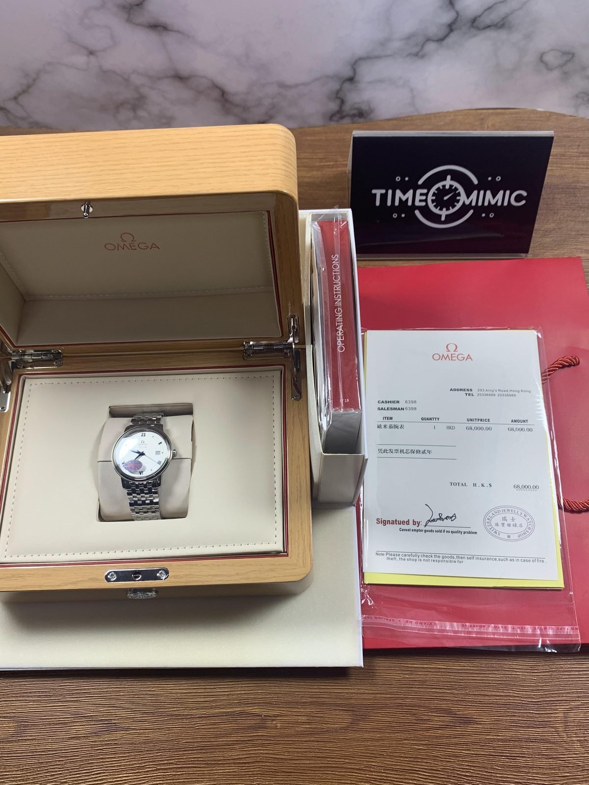 Omega De Ville replica with box accessories and receipt style paper displaying HKD 68000