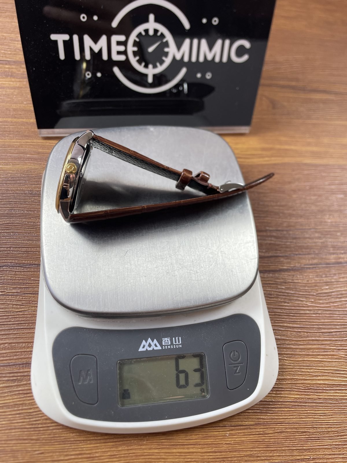 Omega De Ville replica complete watch and open strap on scale reading about 63 grams