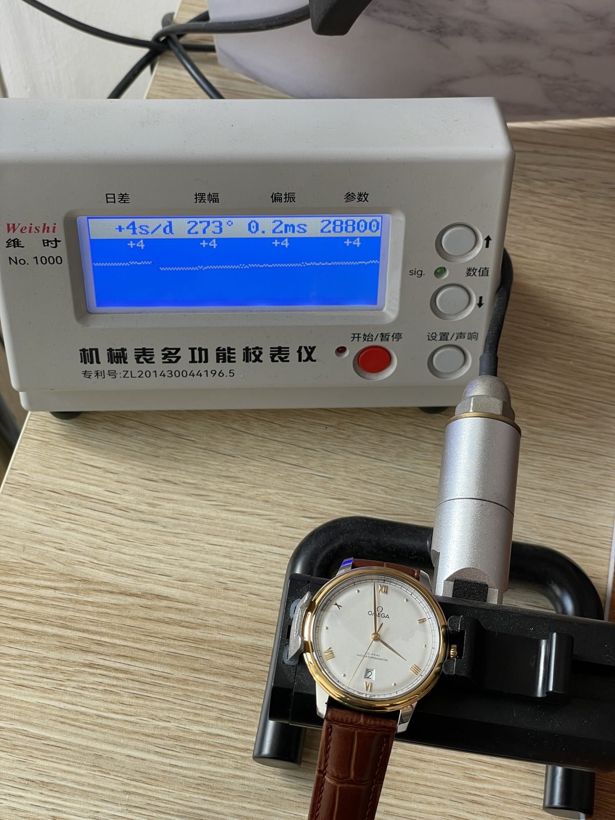Omega De Ville replica on timegrapher style machine showing plus 4 seconds per day 273 degrees 0.2 milliseconds and 28800