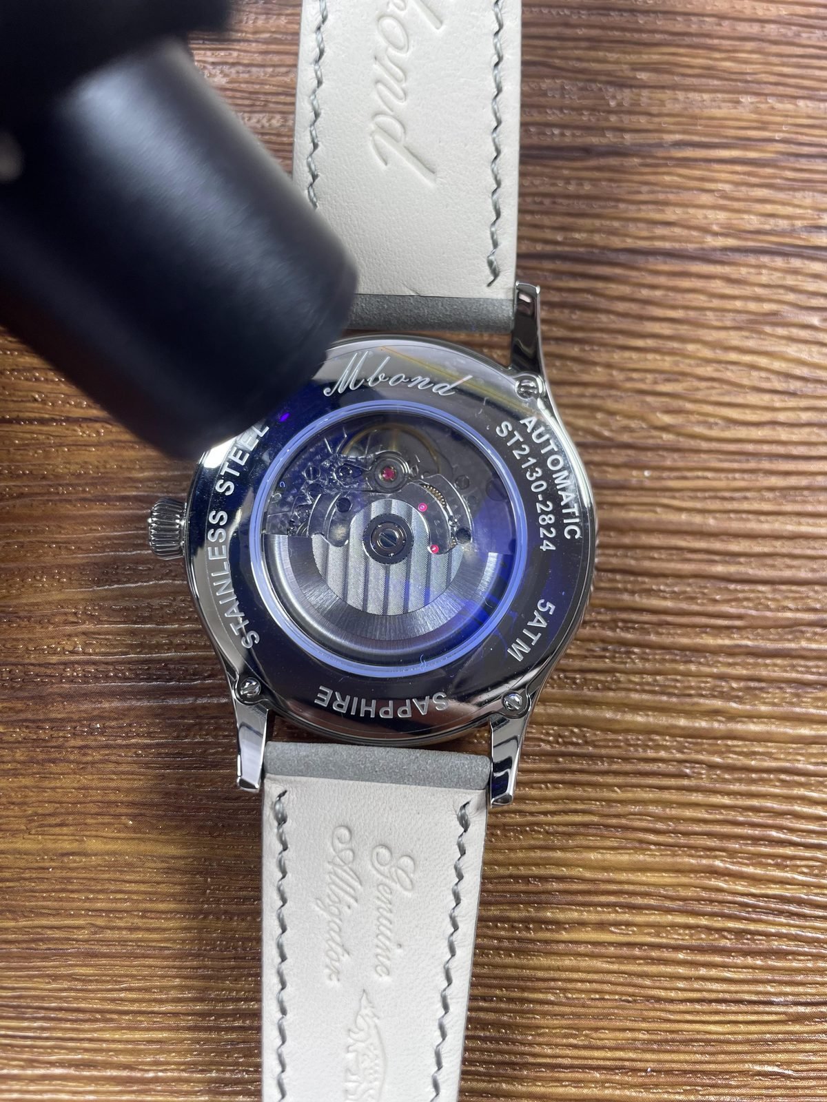 Endeavour style custom replica watch display back under directed blue inspection light