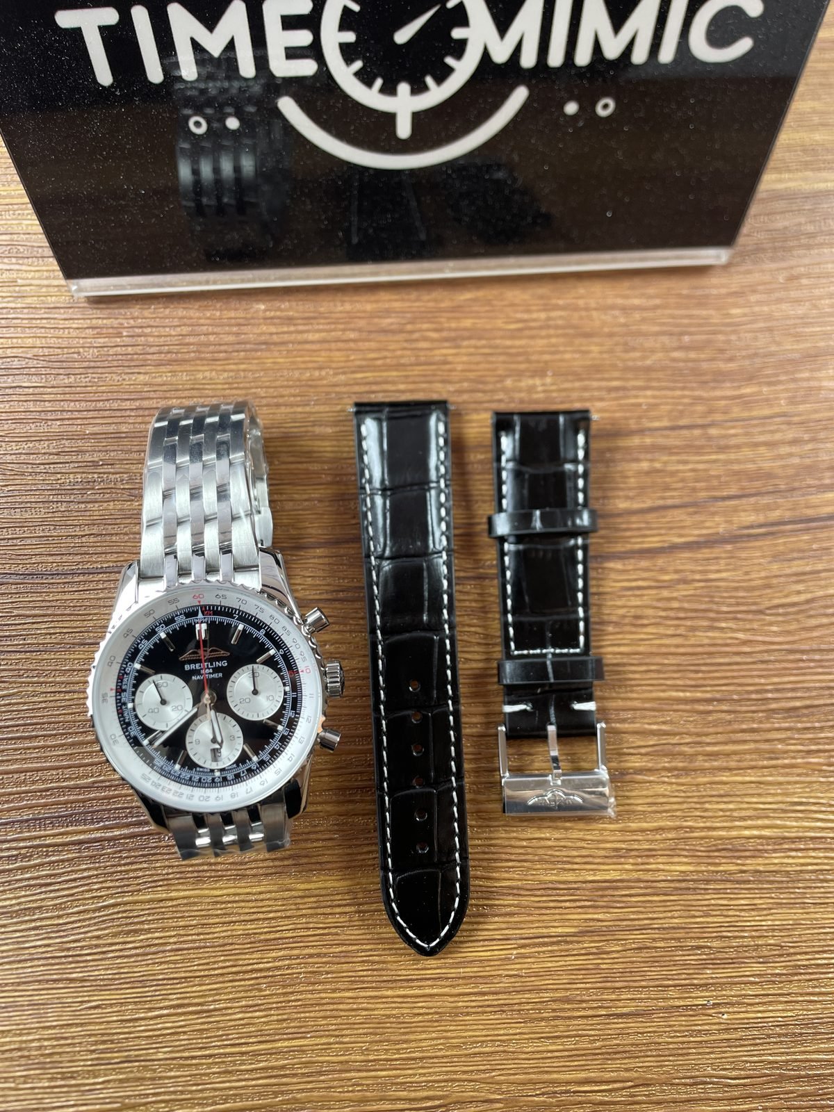 Breitling Navitimer AB0138211B1A1 replica black reverse-panda dial steel-tone multi-row bracelet and separate black embossed strap set