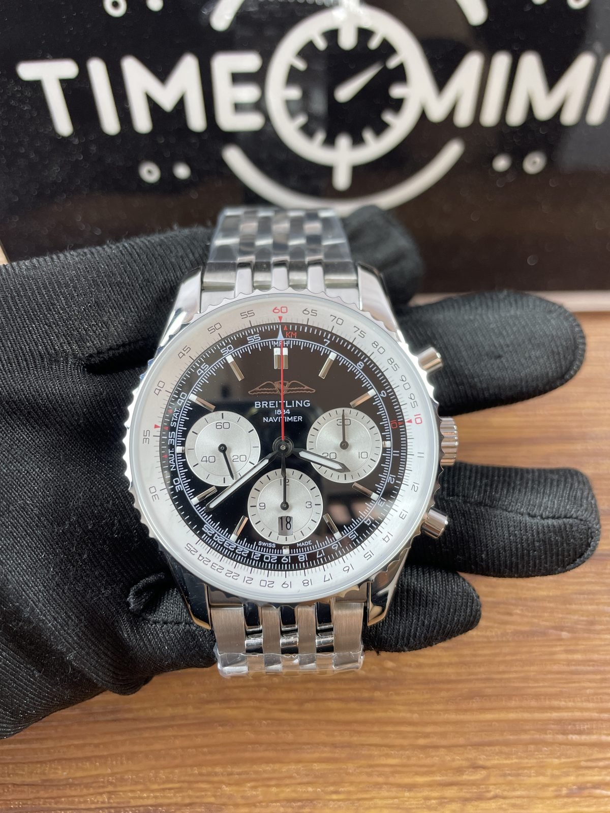 Breitling Navitimer AB0138211B1A1 replica black dial three silver counters red chronograph-style seconds hand date 18 and circular slide-rule scale front
