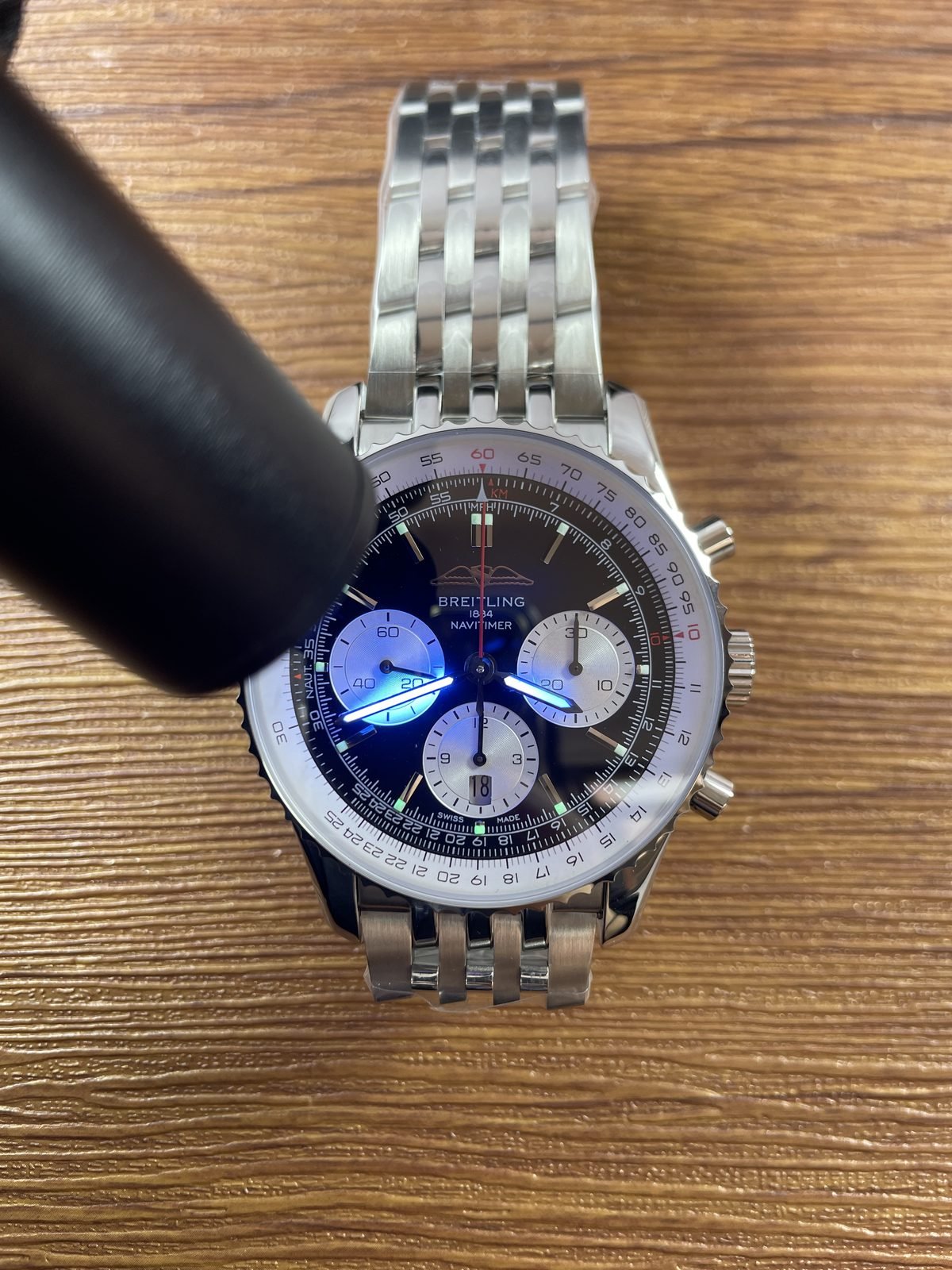 Breitling Navitimer AB0138211B1A1 replica blue hand and green hour-marker lume response under ultraviolet-style light
