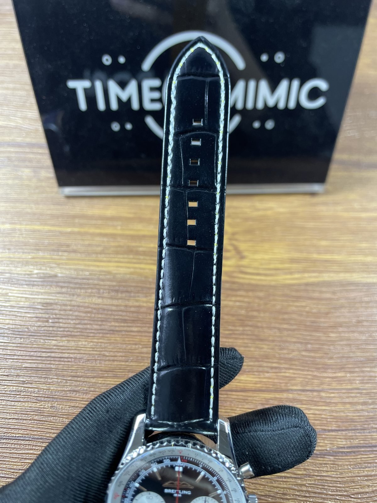 Breitling Navitimer AB0138211B1P1 replica black embossed strap white stitching and punched holes front