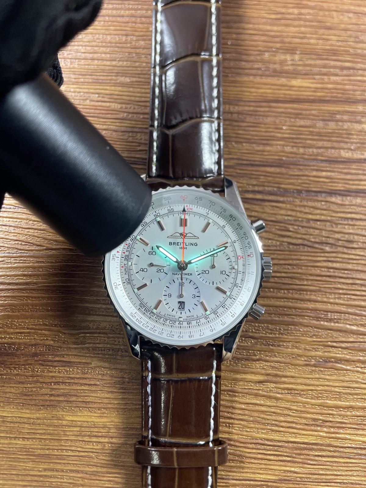 Breitling Navitimer AB0139211G1P1 replica green cyan hand response under ultraviolet-style light