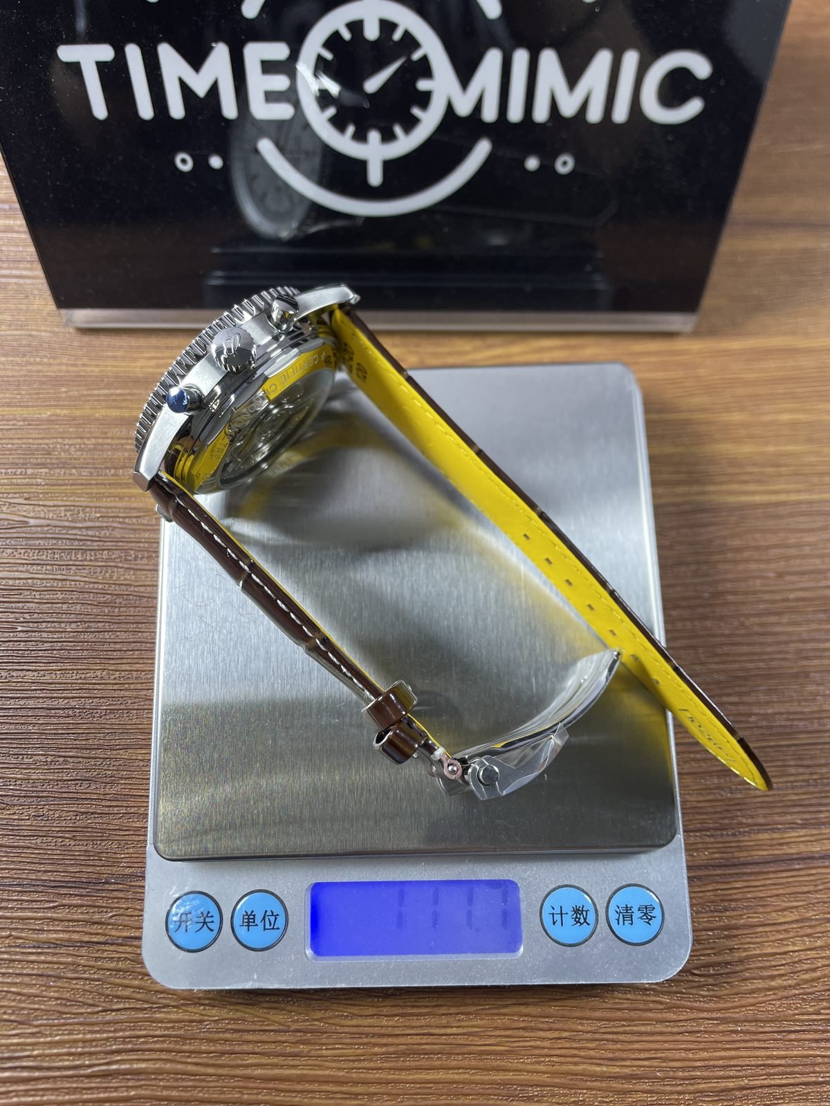 Breitling Navitimer AB0139211G1P1 replica pictured consumer scale reading about 111 grams