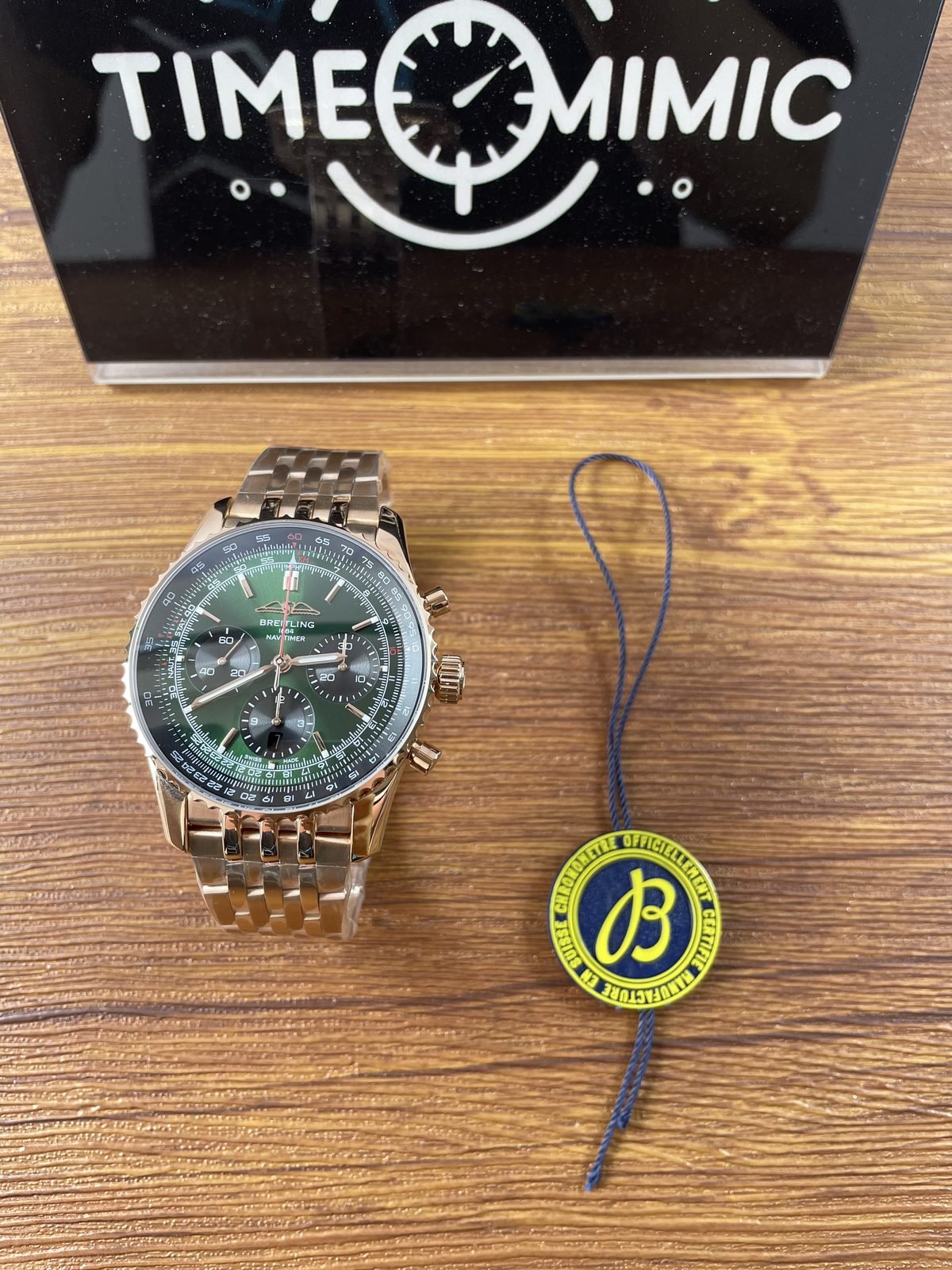 Breitling Navitimer RB0137241L1R1 replica green dial warm tone bracelet beside certification style tag