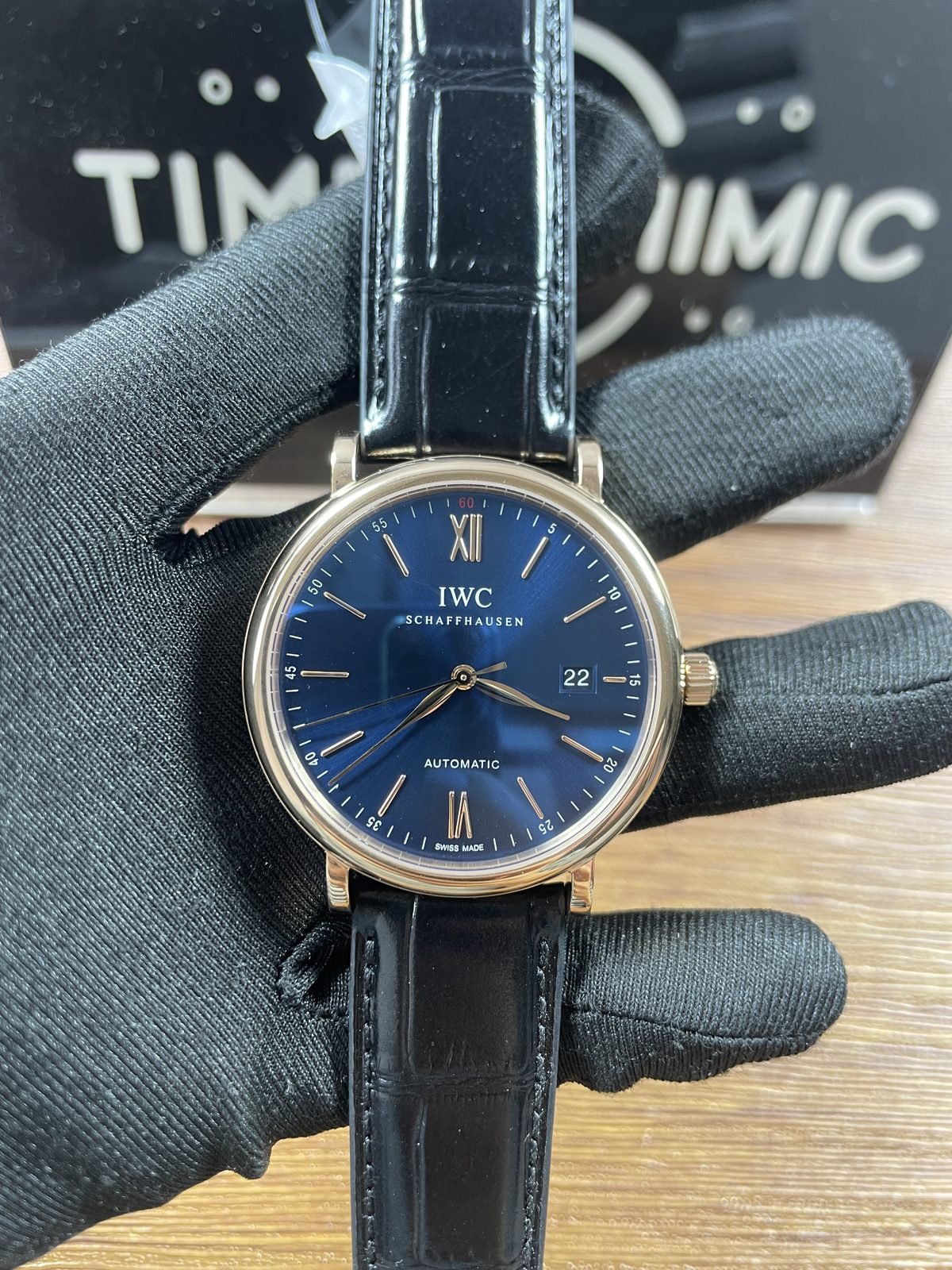 IWC Portofino IW356523 replica blue three hand date dial warm gold tone case black strap front