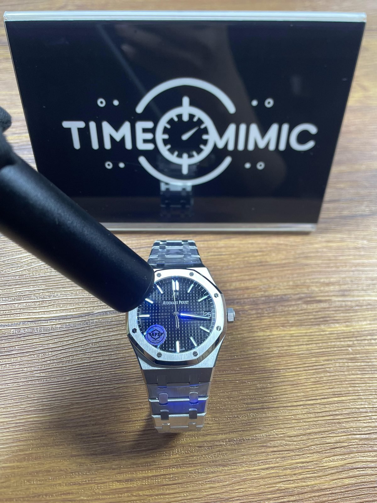 Royal Oak 15510ST 07 replica black dial and markers under blue or ultraviolet-style inspection light