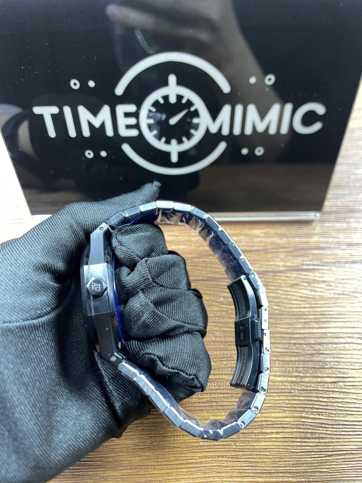 Royal Oak 77350CE replica listing sample dark crown-side profile and open folding clasp under protective film