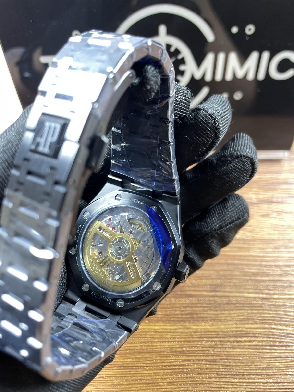 Royal Oak 77350CE replica listing sample exhibition back with decorated automatic-looking movement and warm-tone rotor