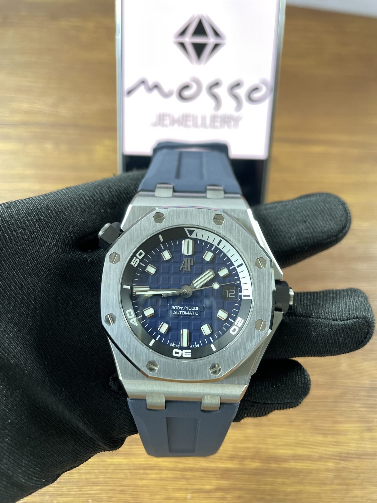 Royal Oak Offshore 15720ST replica handheld front view blue dial date twelve and dark blue strap