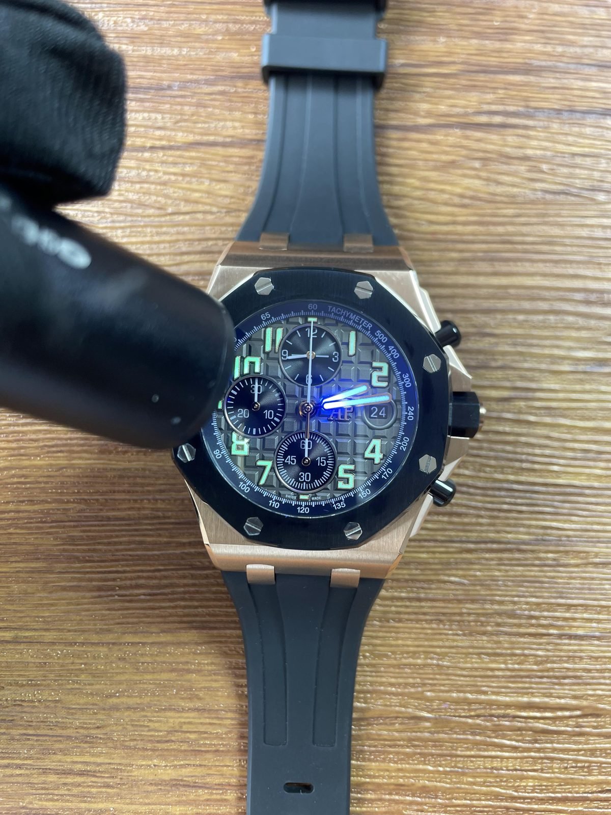 Royal Oak Offshore 26238OK replica illuminated markers and hands under a light source