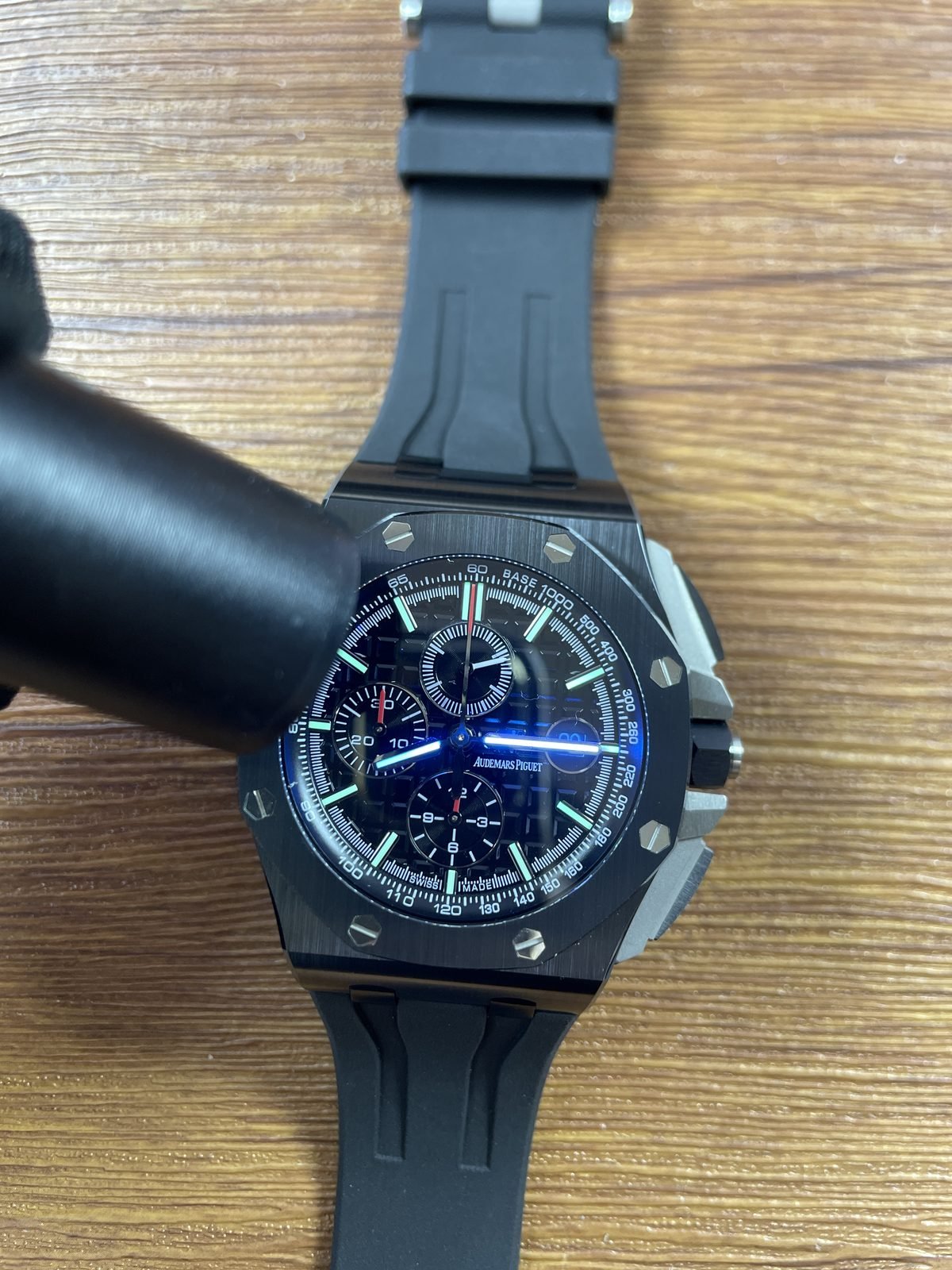 Royal Oak Offshore 26402CE replica illuminated hands and hour markers under a light source