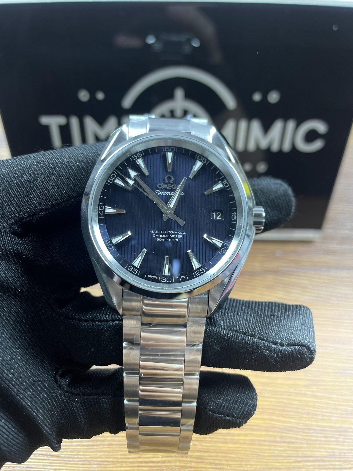 Omega Seamaster replica blue vertical teak style dial 150m text date steel bracelet front