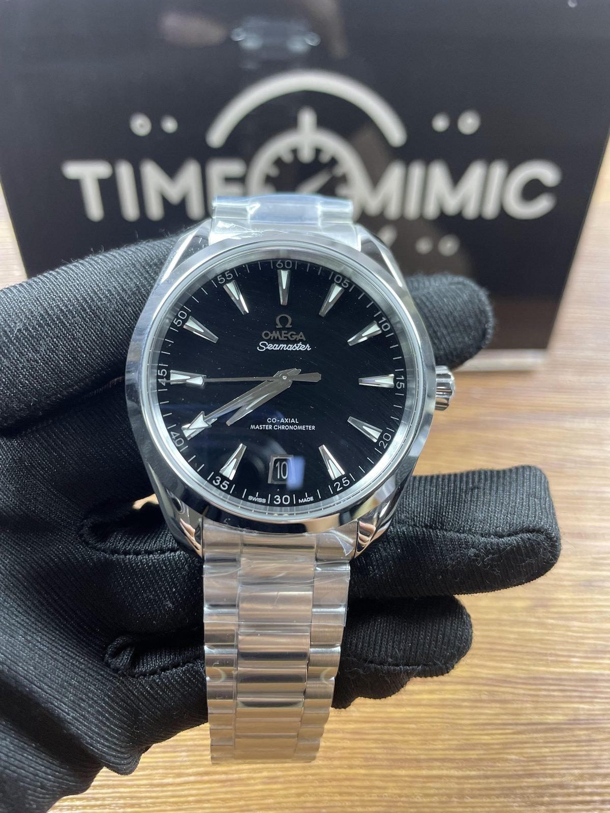 Omega Seamaster replica black lacquer-style dial 150m text date steel bracelet front