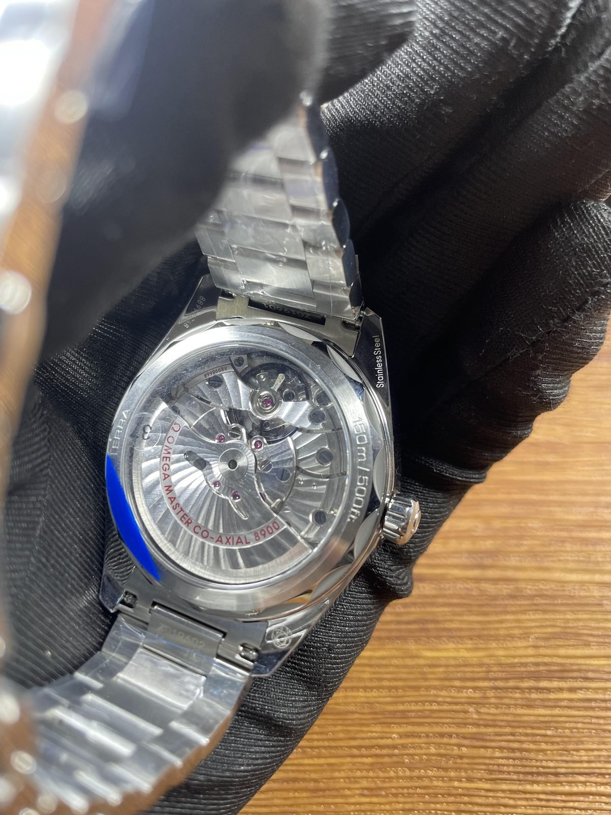 Steel tone folding butterfly style clasp exterior under protective film