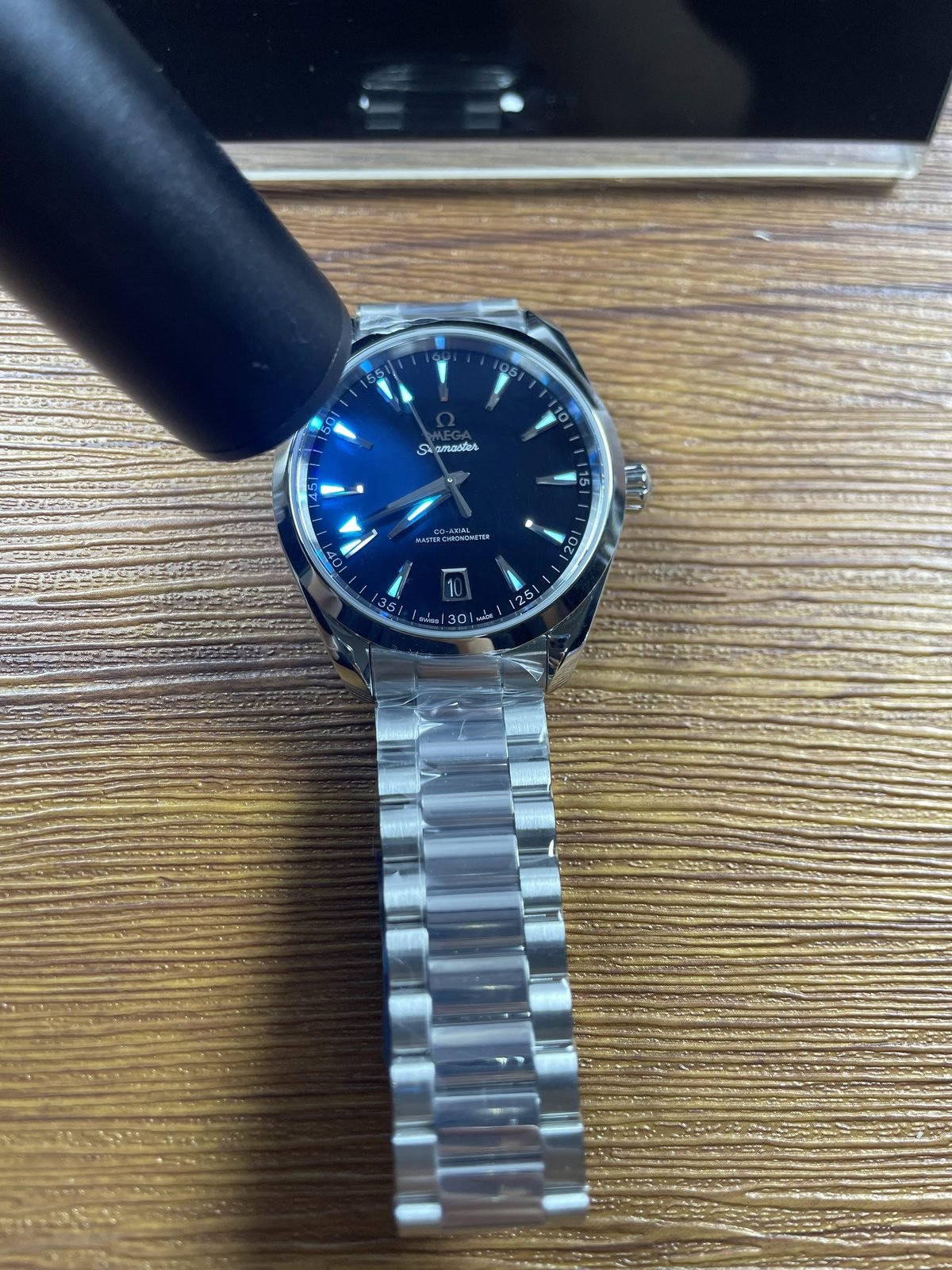 Black lacquer-style dial immediate blue lume response under directed light