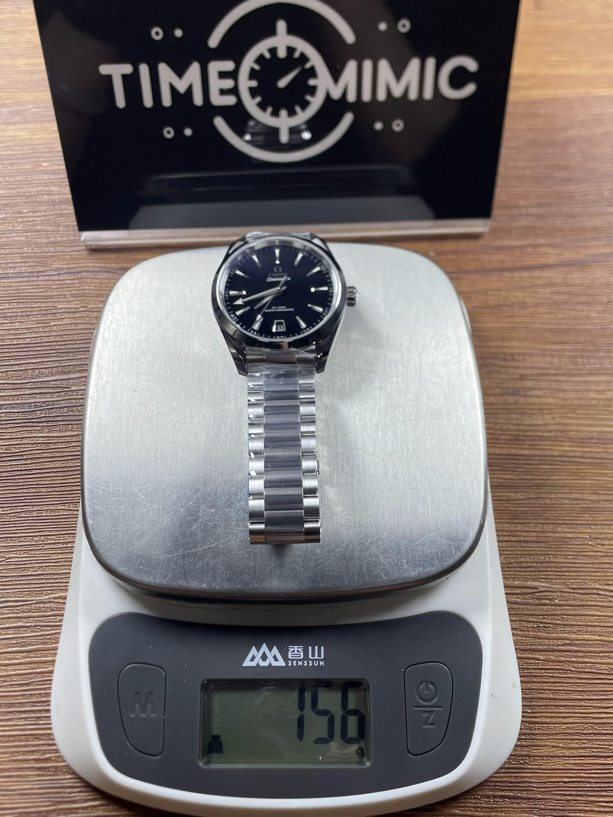 Complete steel tone bracelet watch on scale reading about 156 grams