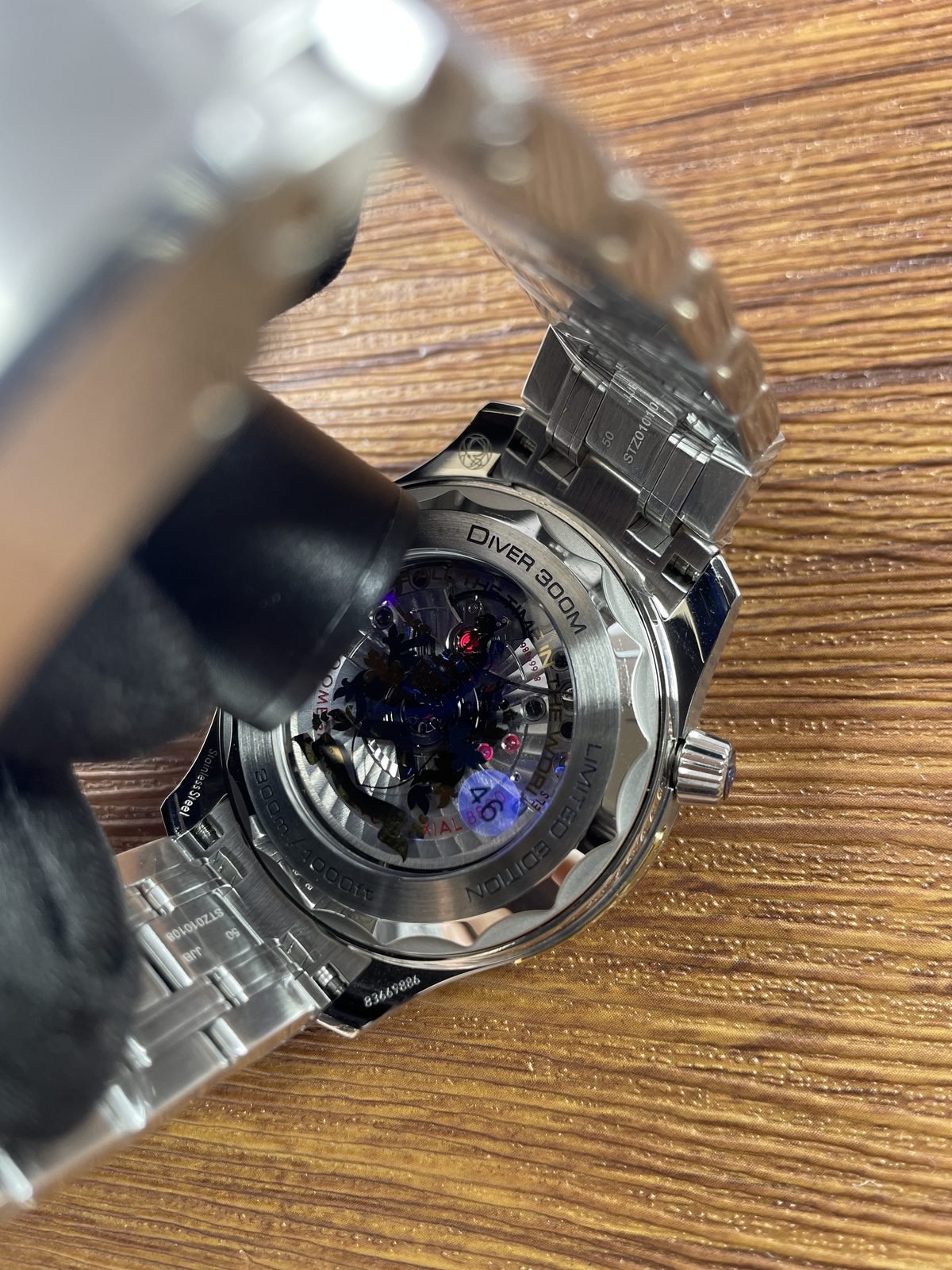 Transparent back with dark crest style decoration and Diver 300M limited edition markings