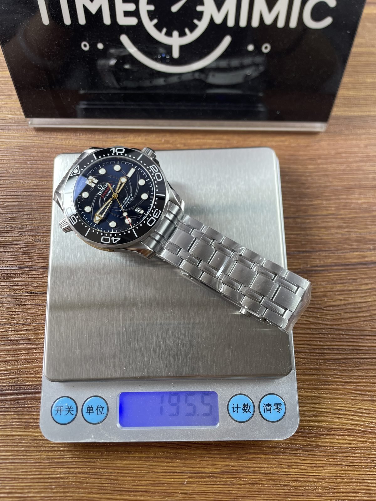 Complete steel bracelet watch on scale reading about 195.9 grams