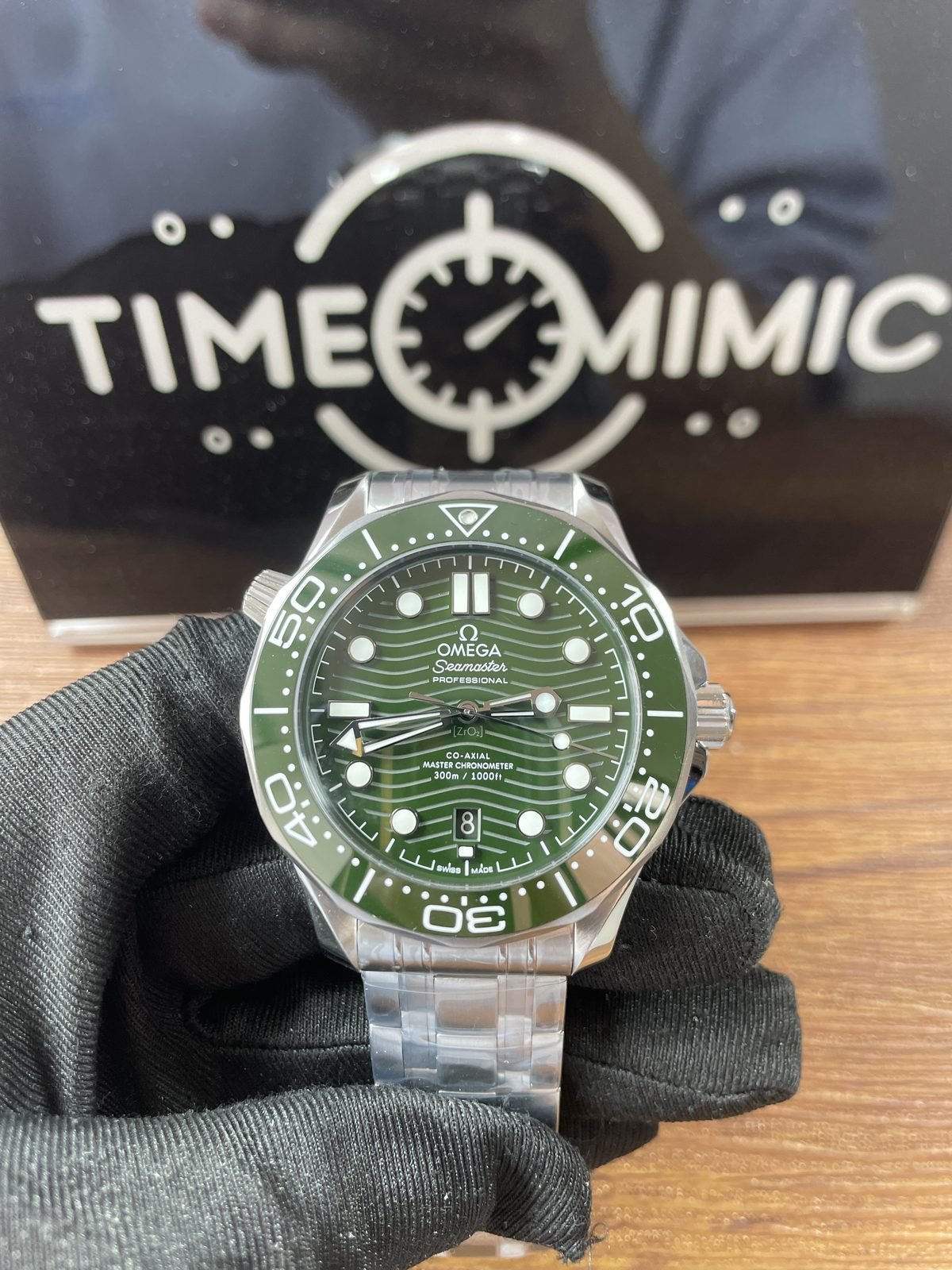 Green dial and green bezel Omega Seamaster Diver 300M style replica front view on steel bracelet