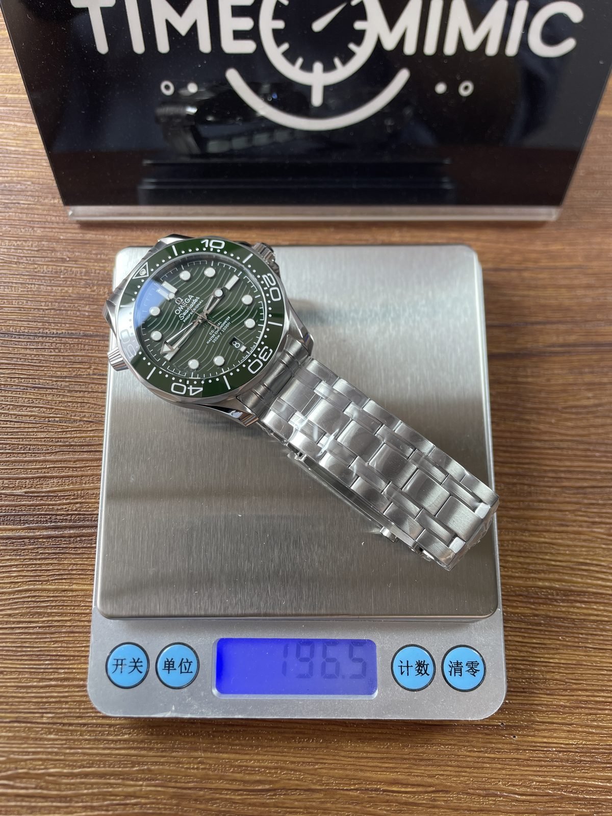 Protected steel bracelet watch on digital scale reading about 196.5 grams