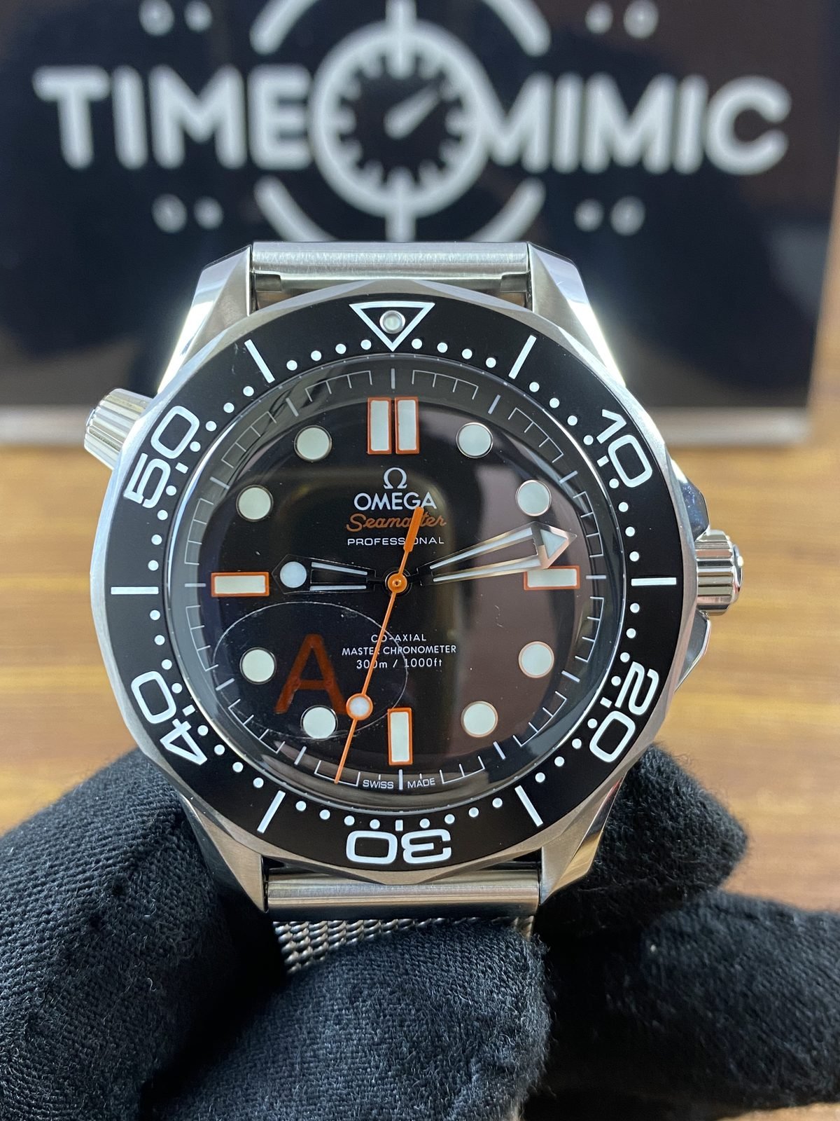 Omega Seamaster Diver 300M 210.30.42.20.01.018 style replica black no date dial orange accents and mesh bracelet front