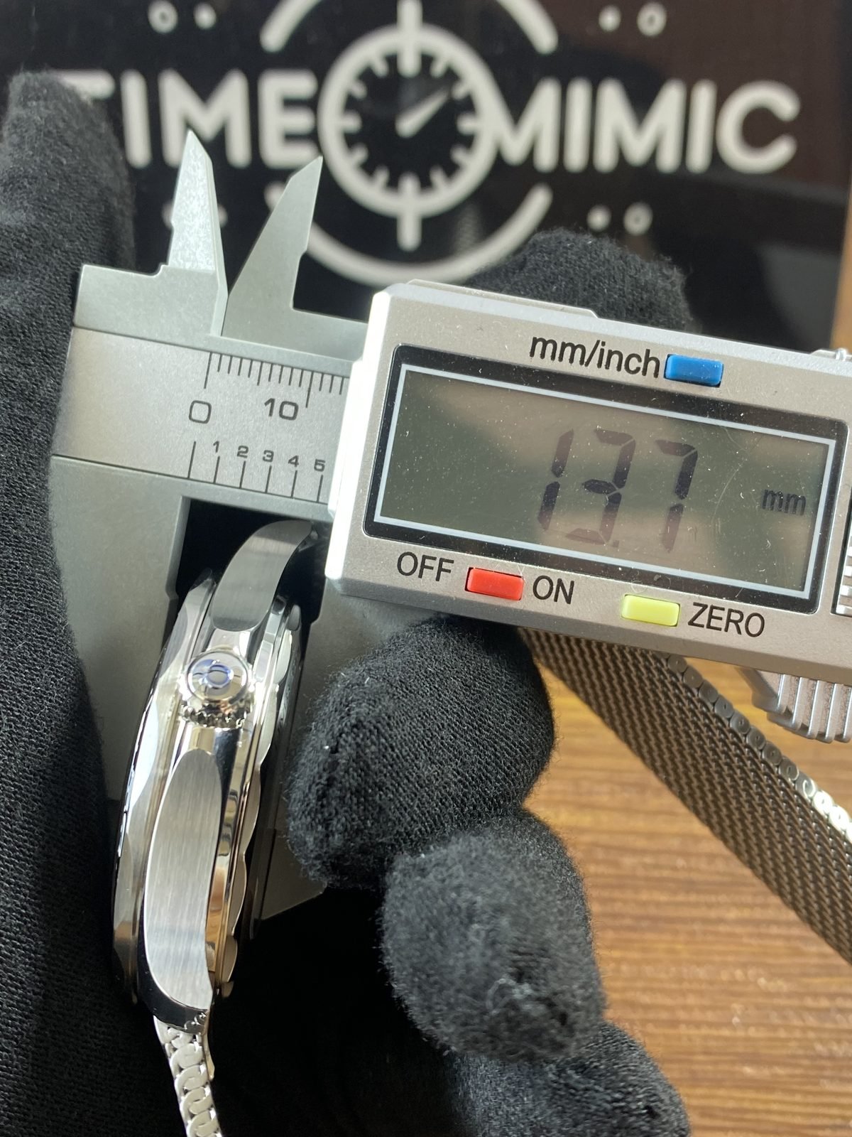 Digital calliper reading about 13.7 millimetres on the photographed watch thickness