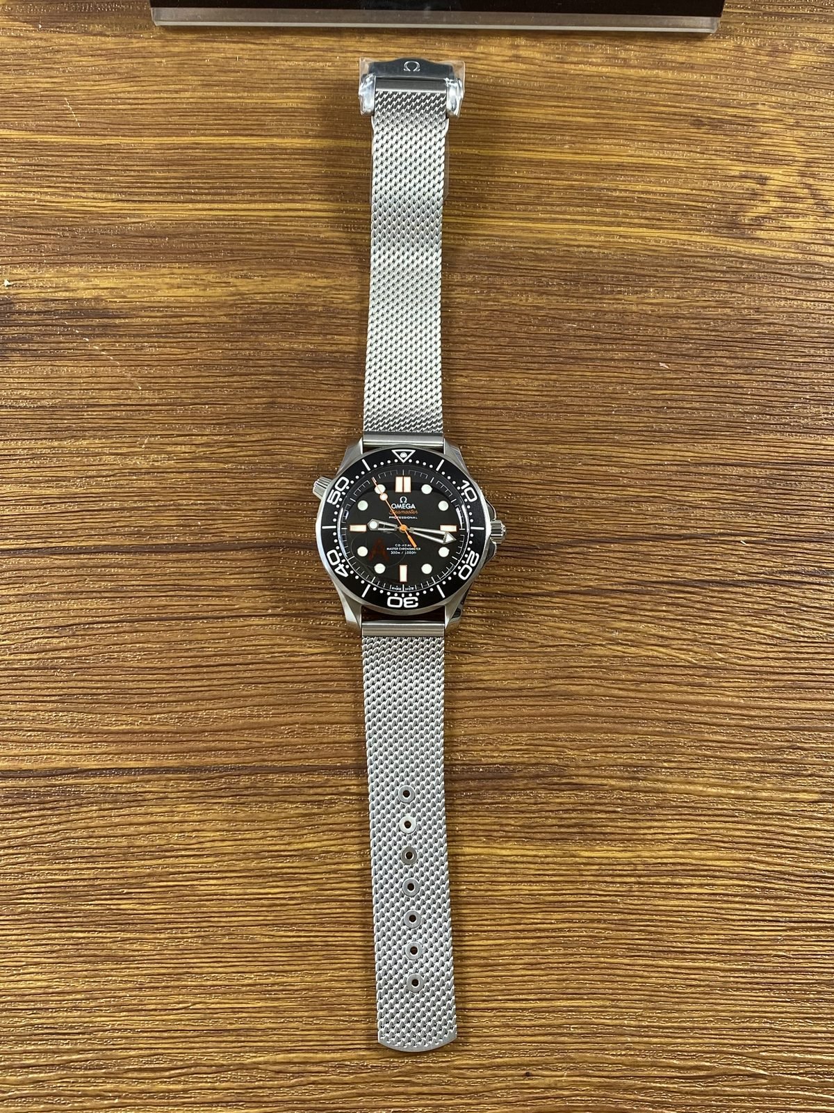 Full length black orange no date Seamaster style replica on mesh bracelet