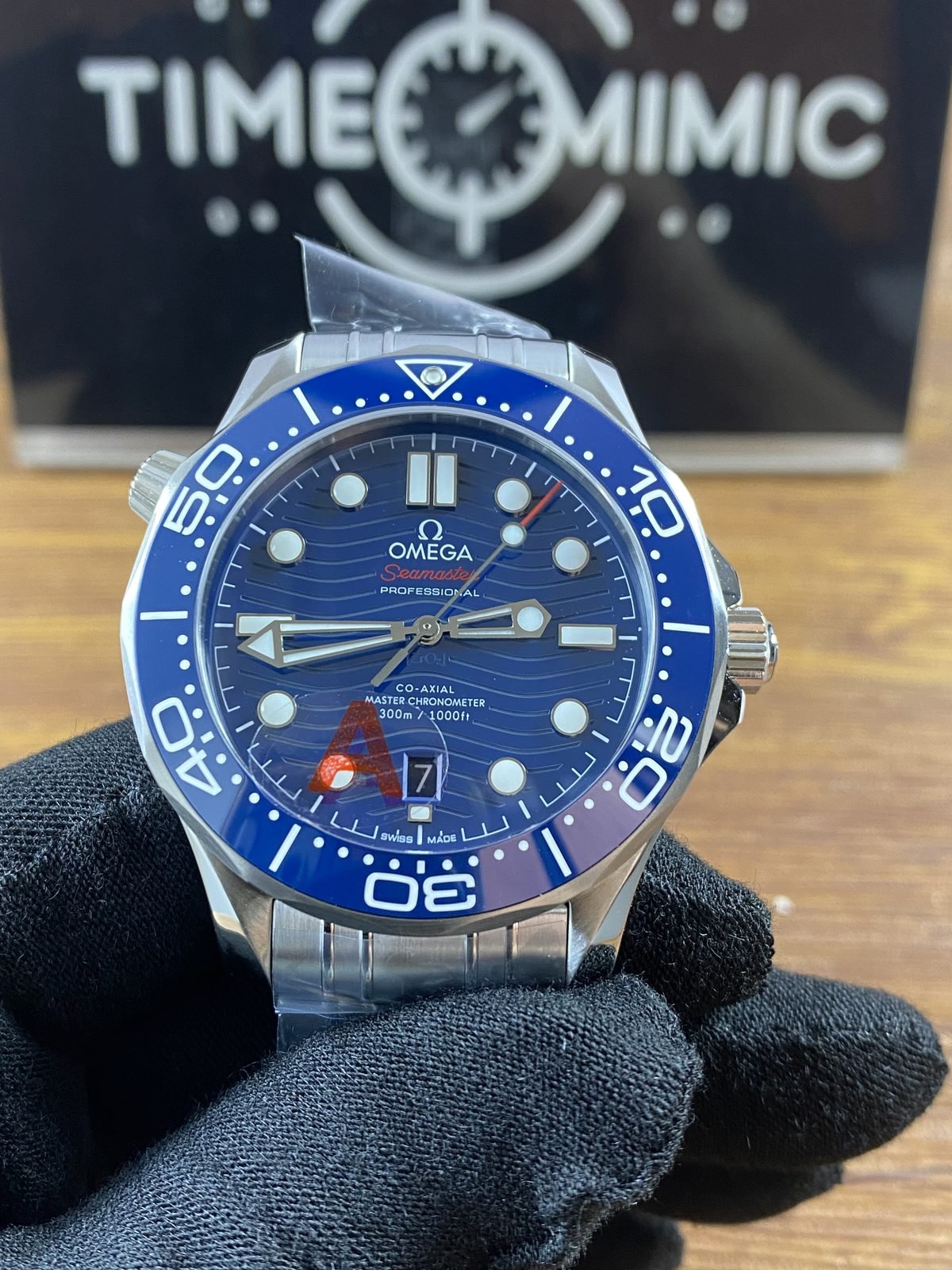 Centered blue dial six o'clock date Seamaster Diver 300M style replica on steel tone bracelet