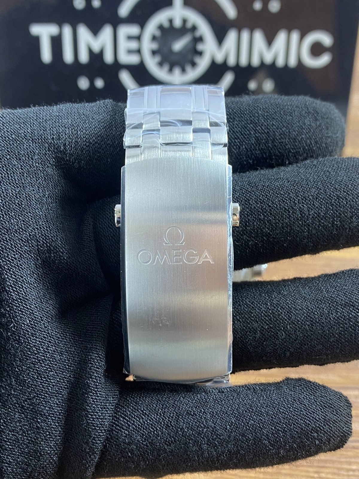 Broad brushed Omega style foldover clasp exterior on steel tone bracelet