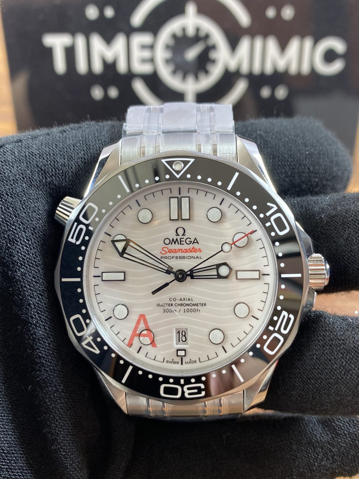 Close front view of white wave dial and black bezel Omega Seamaster 210.30.42.20.04.001 style replica