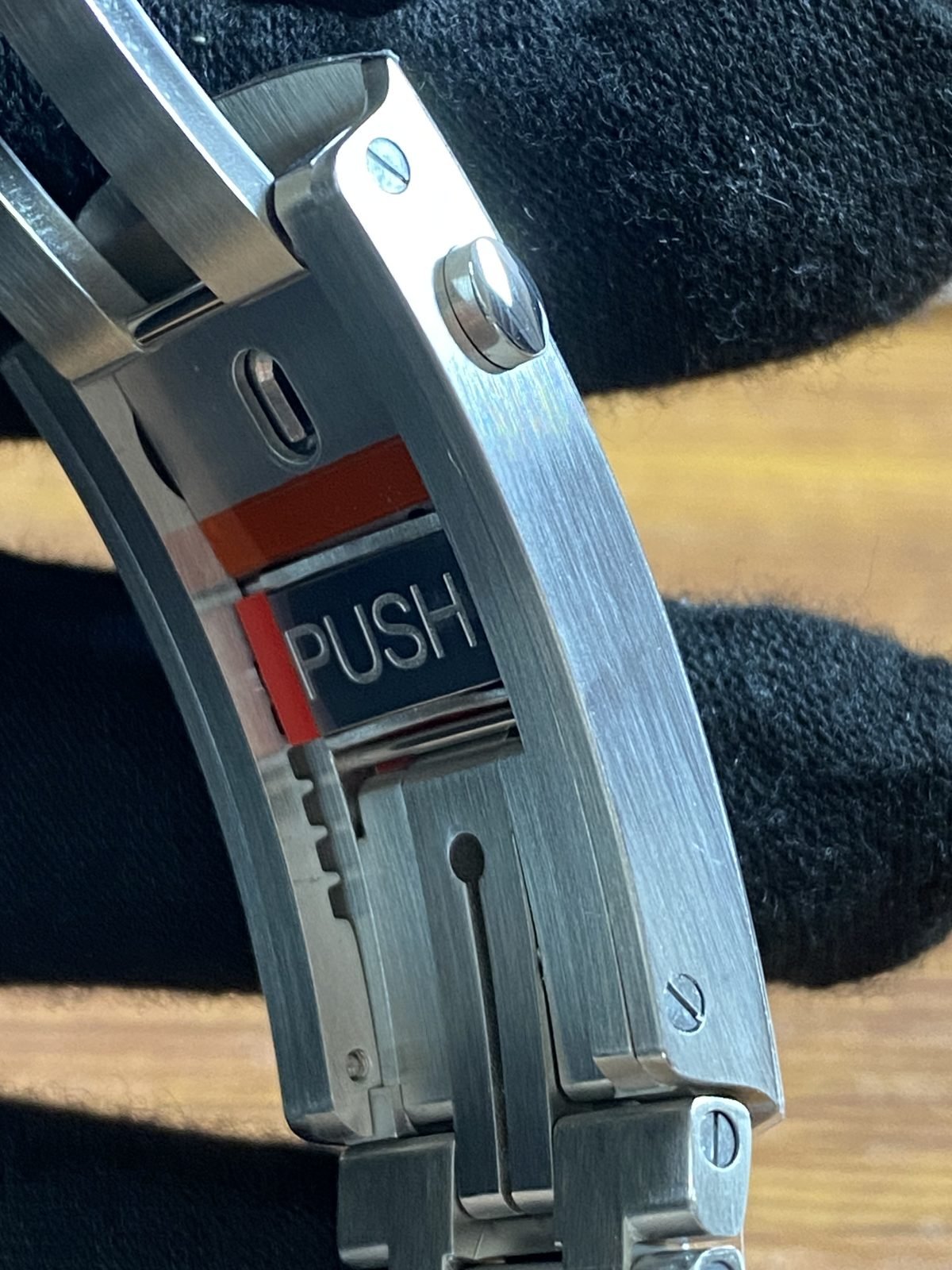 Close view of push control and adjustment extension style clasp hardware