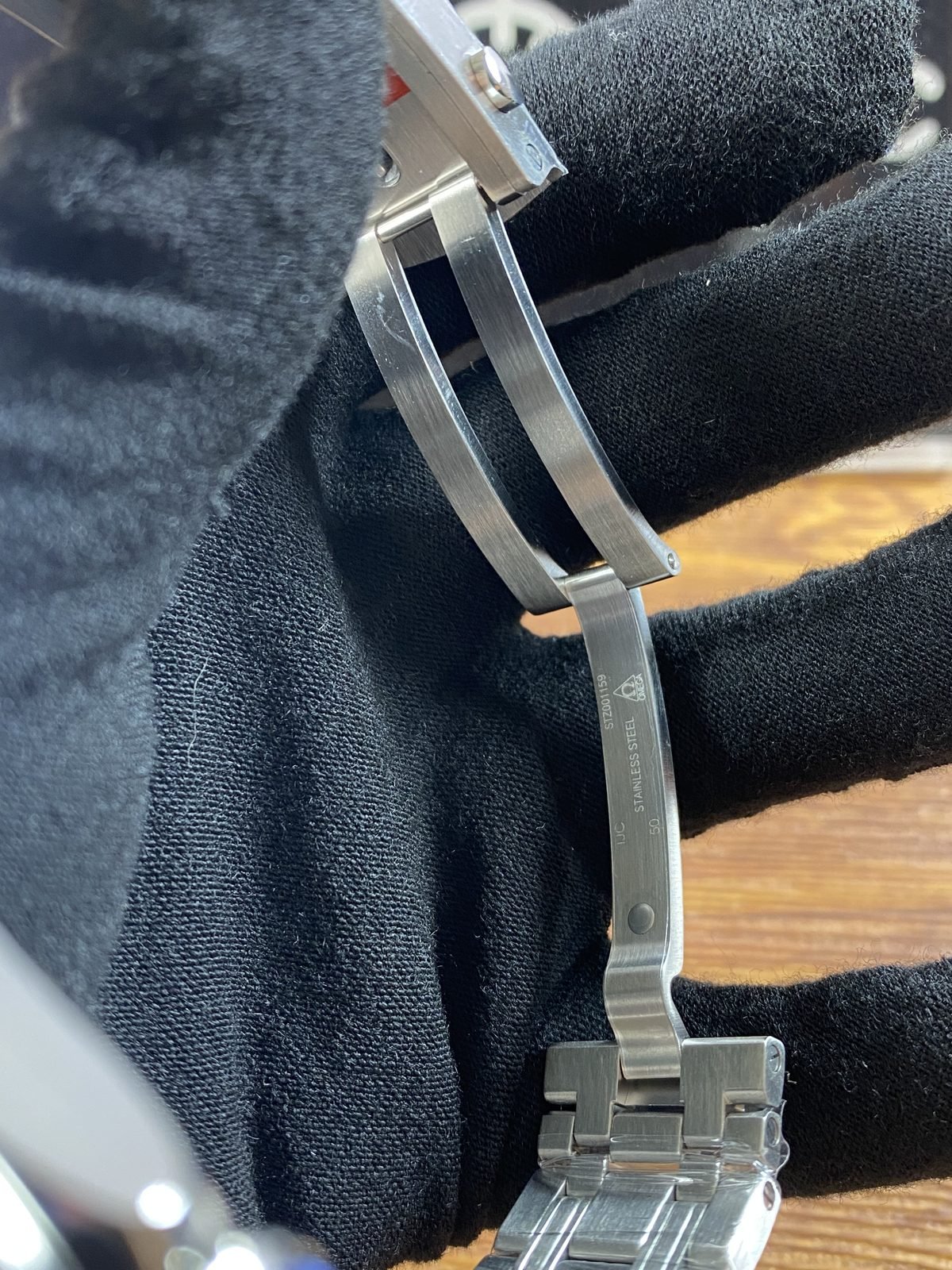 Full open clasp view showing blade geometry markings and bracelet links