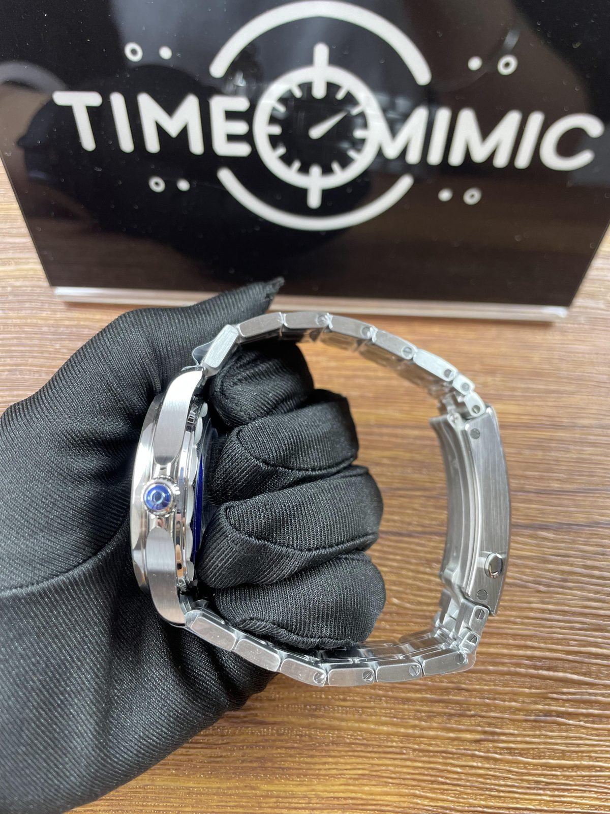 Side profile and open clasp of green Seamaster style replica on steel tone bracelet