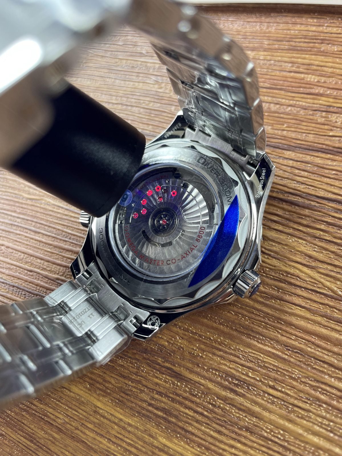 Transparent wave edged back with decorated automatic looking movement and Master Co Axial 8800 style text