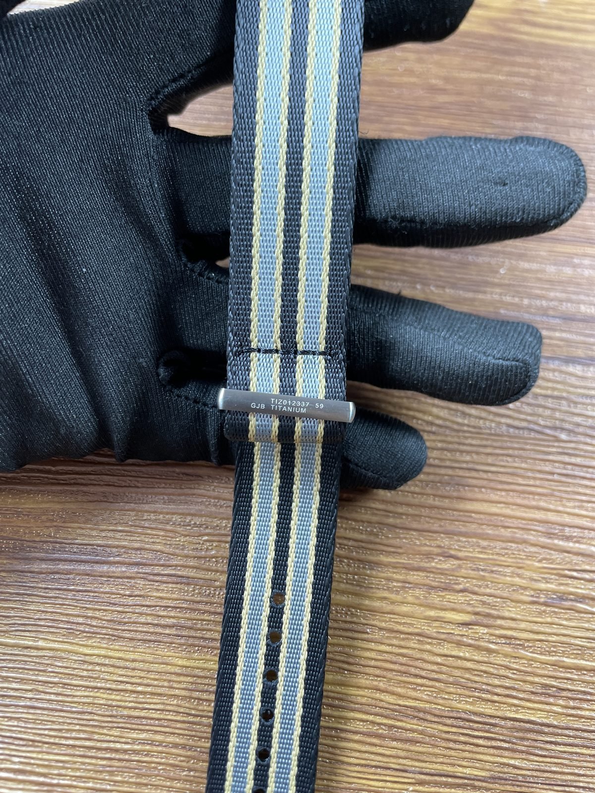 Striped woven strap keeper with TIZ012337 59 GJB and TITANIUM style markings